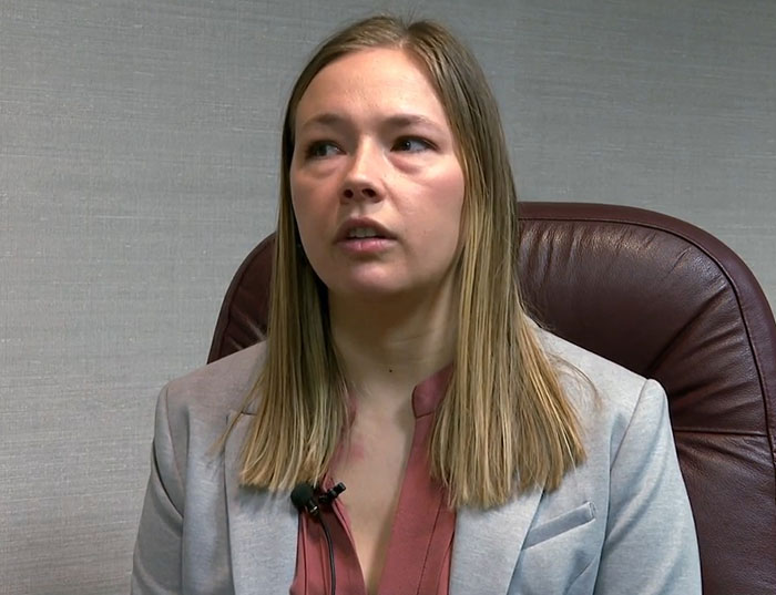 Woman with long hair and blazer sharing eerie details about being held captive in soundproof bunker by stalker.