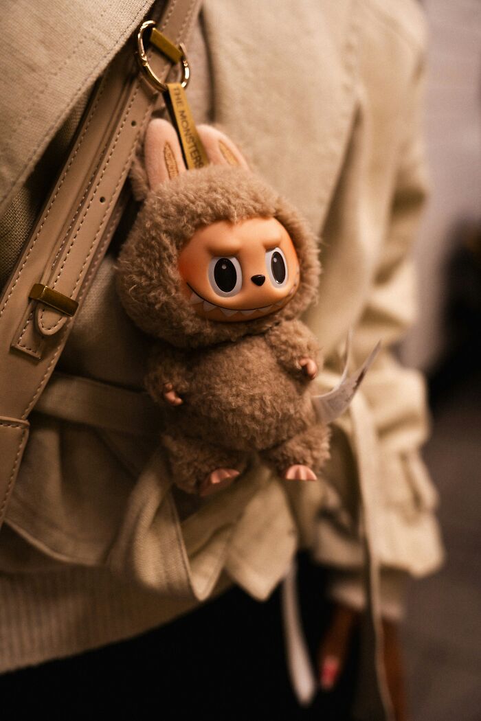 Plush keychain attached to a beige bag, illustrating unique scams likely to fool a millennial audience.