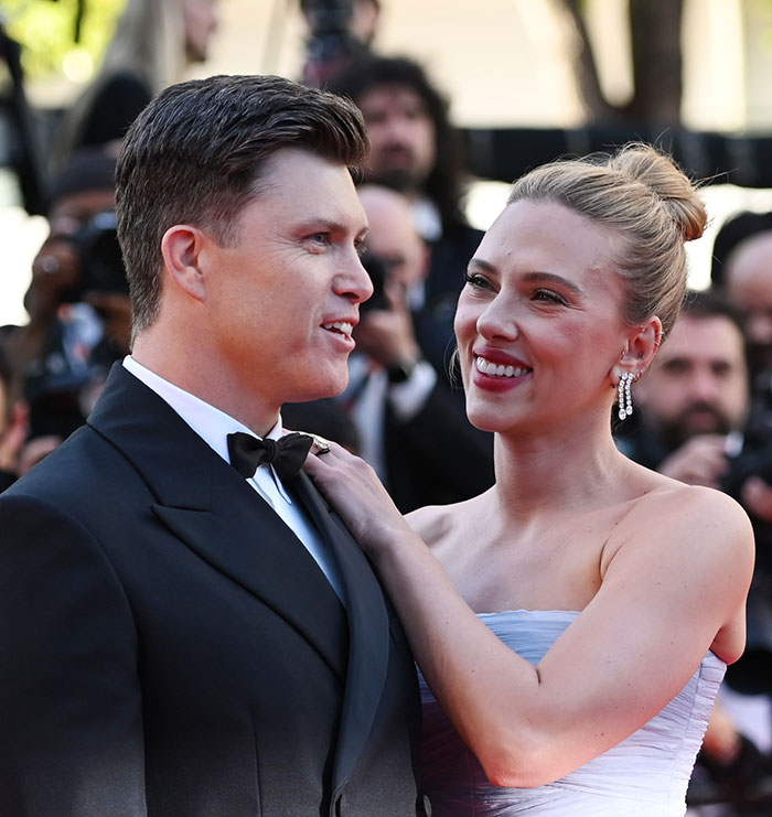 Jonathan Bailey and Scarlett Johansson smiling together at a formal event sparking heated reactions about cheating.