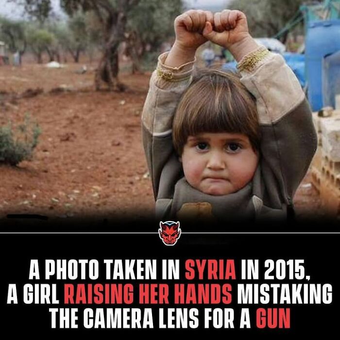 Young girl raising her hands in Syria looking scared, fitting the theme of random creepy facts and pictures.