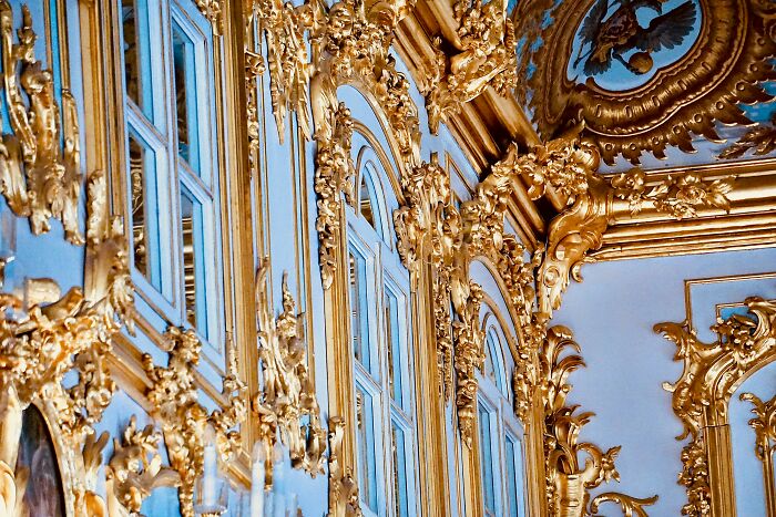 Ornate room interior with intricate gold decorations and tall windows reflecting an alpha vibe of excess and overcompensation. - 3