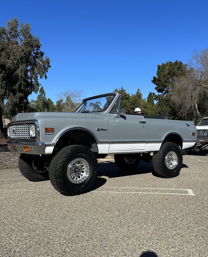 Lifted classic convertible truck parked outdoors under clear blue sky, showcasing bold alpha vibe and overcompensating traits. - 28