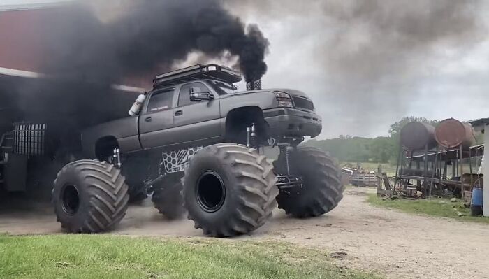 Monster truck emitting thick black smoke, showcasing bold power and the whole alpha vibe in an off-road setting. - 16