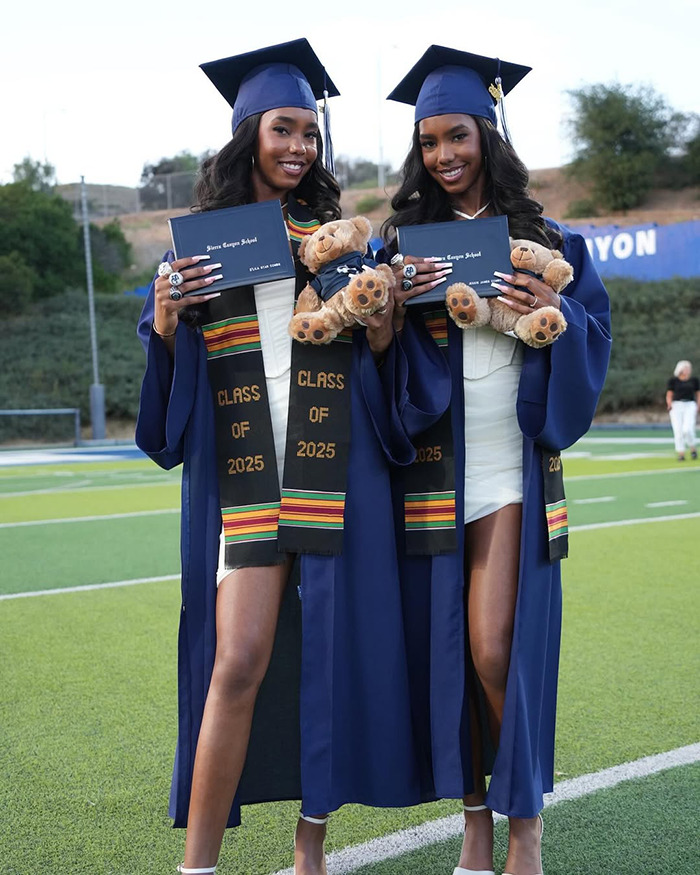 Sean Diddy's twin daughters in graduation caps and gowns holding diplomas and teddy bears celebrating their achievement.