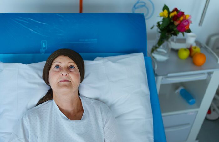Woman lying in hospital bed with headscarf, reflecting on disturbing facts that don’t help to sleep at night.