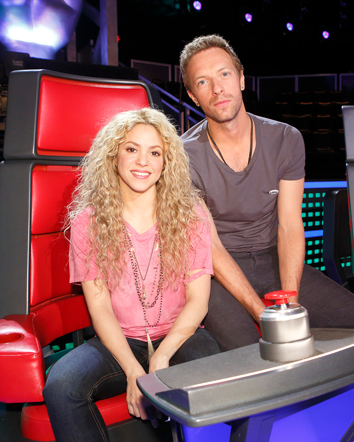 Shakira and Chris Martin seated together onstage during a show, sparking fans to speculate on their romance.