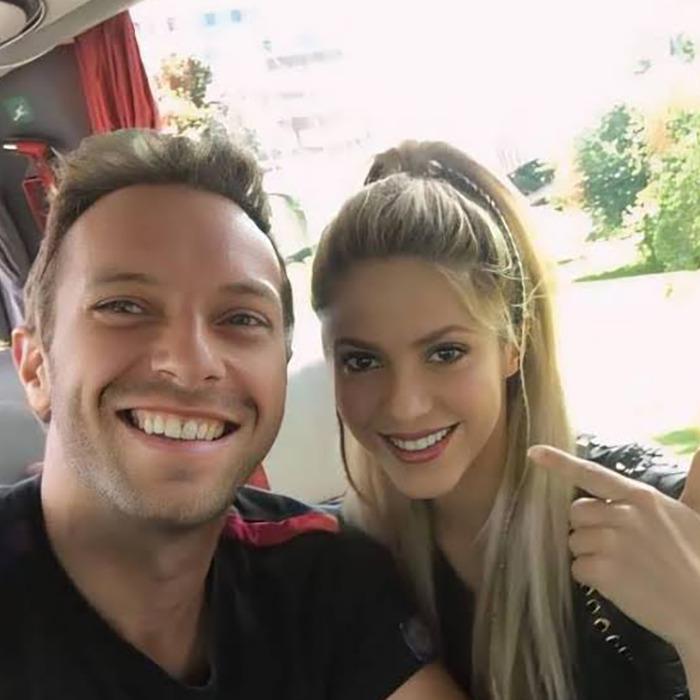 Shakira and Chris Martin smiling together, sparking fans' speculation on romance after emotional onstage moment.