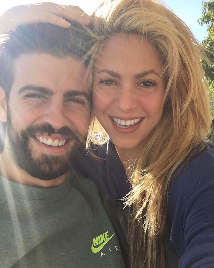 Shakira and Chris Martin smiling together outdoors in a close-up selfie sparking fans' romance speculation.