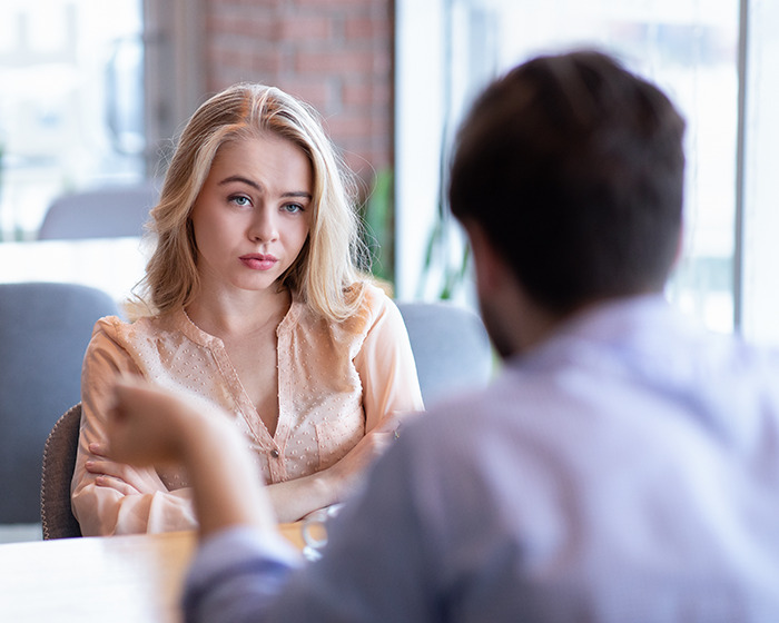 Young woman on a tense date with an older man, illustrating TikTok woman's horror date and red flag debate. Young woman on a tense date with an older man, illustrating TikTok woman's horror date and red flag debate.