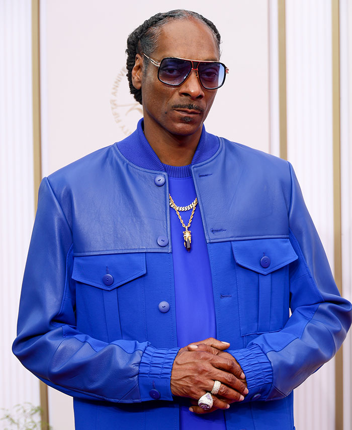 Snoop Dogg wearing blue jacket and sunglasses, sparking outrage over LGBTQ+ representation in kids’ films. Snoop Dogg wearing blue jacket and sunglasses, sparking outrage over LGBTQ+ representation in kids’ films.