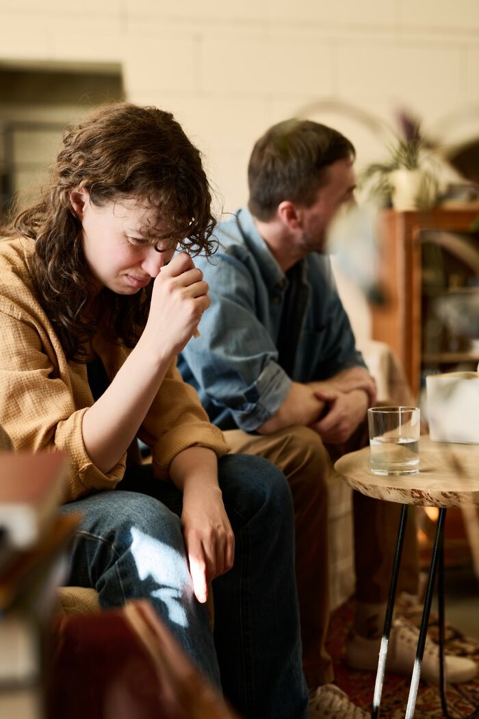 Woman upset and man ignoring her during a tense moment, illustrating people getting savagely rejected in relationships.