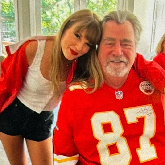 Taylor Swift with a fan, highlighting Travis Kelce's hidden engraving on her $1M engagement ring in a casual setting. Taylor Swift with a fan, highlighting Travis Kelce's hidden engraving on her $1M engagement ring in a casual setting.
