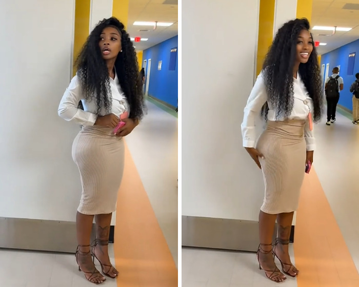 Teacher standing in a hallway wearing a fitted skirt and blouse, sparking viral debate over showing off curves.