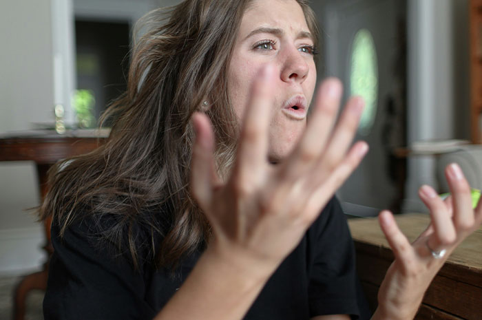 Young woman expressing frustration and anger during a heated family fallout about running away from her half-sister. Young woman expressing frustration and anger during a heated family fallout about running away from her half-sister.