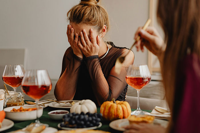 Young woman covering her face during a tense family dinner, illustrating a fallout between half-sisters after a runaway confession. Young woman covering her face during a tense family dinner, illustrating a fallout between half-sisters after a runaway confession.