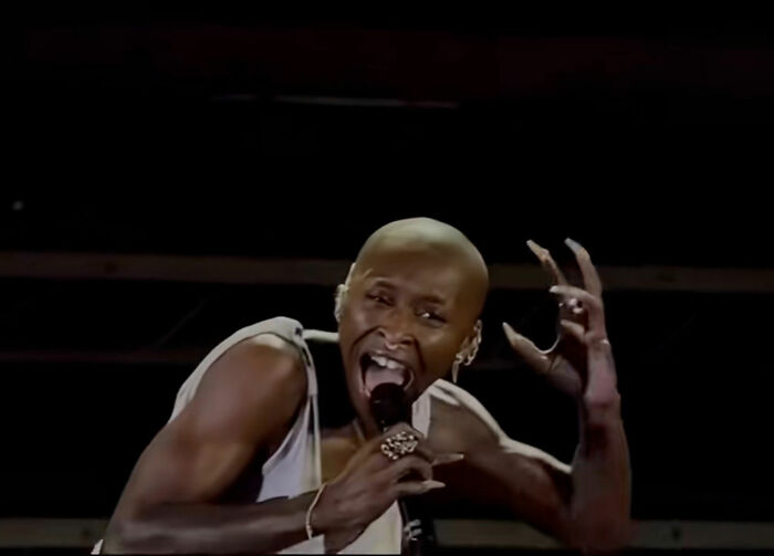 Cynthia Erivo performing with long nails, passionately singing on stage with a microphone, sparking mass outrage as Jesus. Cynthia Erivo performing with long nails, passionately singing on stage with a microphone, sparking mass outrage as Jesus.
