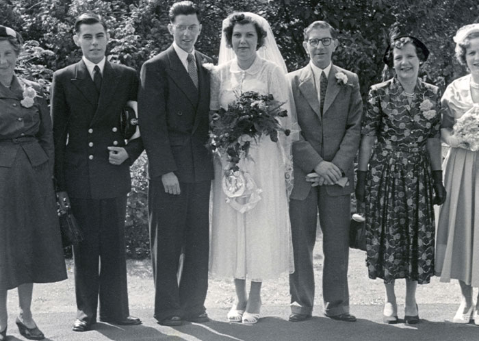 Vintage black and white wedding photo showing a bride, groom, and family, symbolizing things not mentioned until after marriage.
