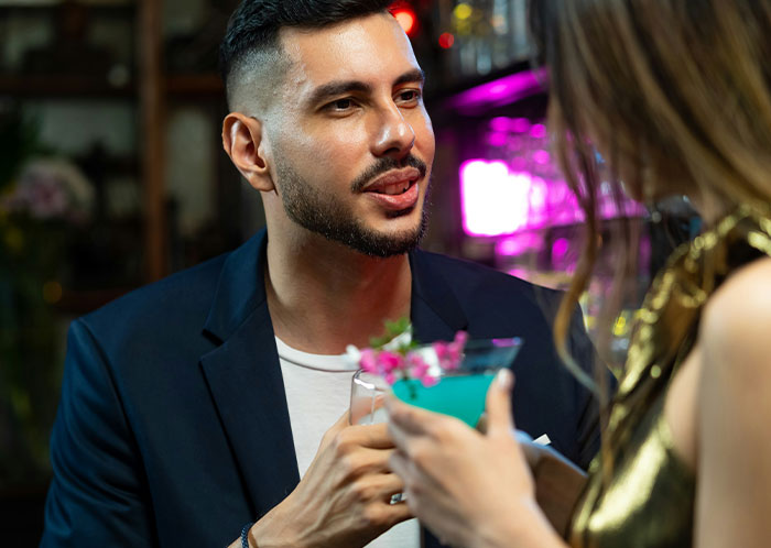 Man and woman having drinks and conversation, illustrating things that weren’t mentioned until after marriage.