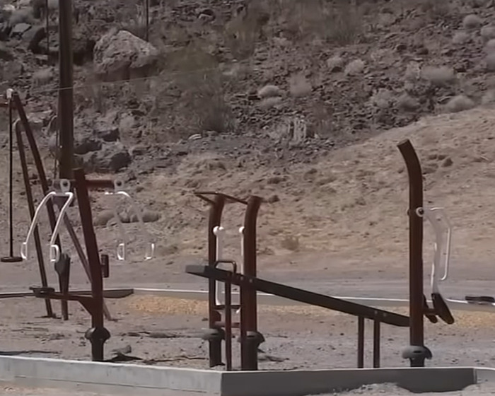 Empty outdoor playground equipment against a rocky, barren background, relating to teen daughter's heartbreaking dog mauling incident.