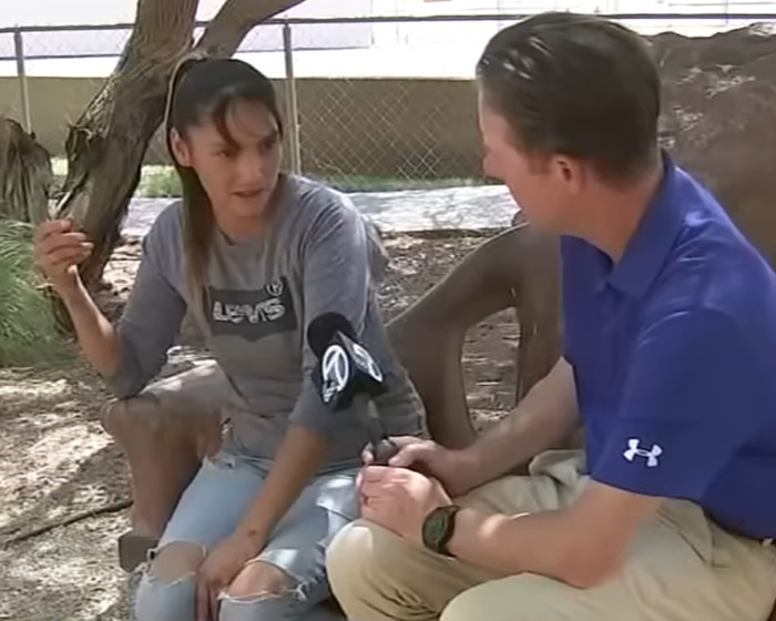 Teen daughter speaking to reporter outdoors after being mauled by pack of dogs, sharing her heartbreaking story.