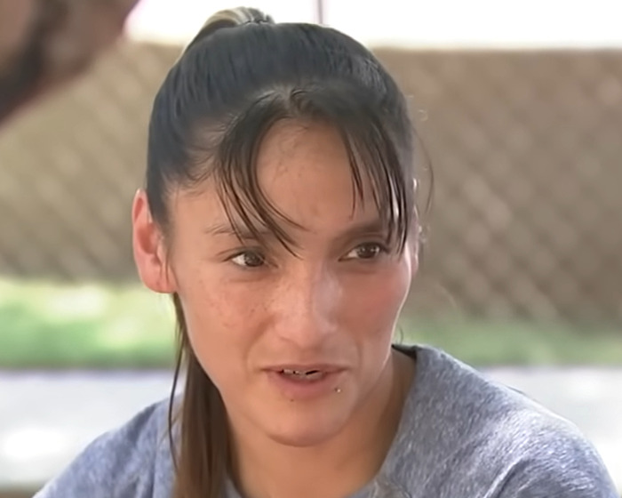 Teen daughter with emotional expression, sharing her heartbreaking experience after being mauled by pack of dogs.