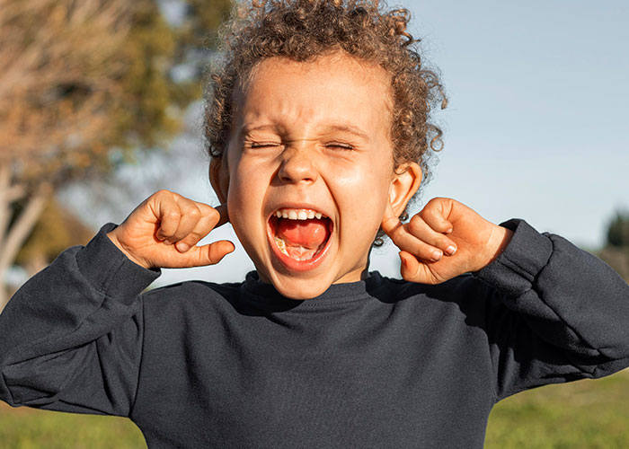 Child making a playful face outdoors while woman keeps her promise to train cousin’s kids after babysitting. Child making a playful face outdoors while woman keeps her promise to train cousin’s kids after babysitting.
