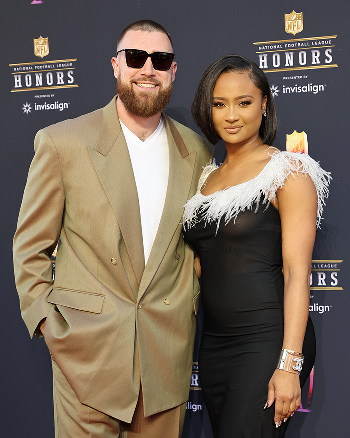 Travis Kelce and his ex posing on the red carpet at the NFL Honors event, dressed in formal attire.