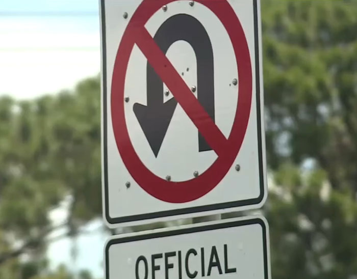 No U-turn traffic sign displayed on a pole, highlighting illegal truck driver maneuver risks and road safety.