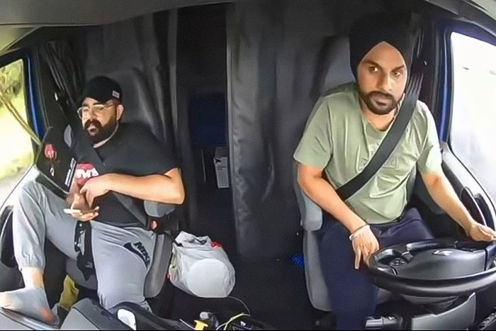 Two truck drivers inside the cabin, one making an illegal U-turn contributing to a fatal accident with three lives lost.