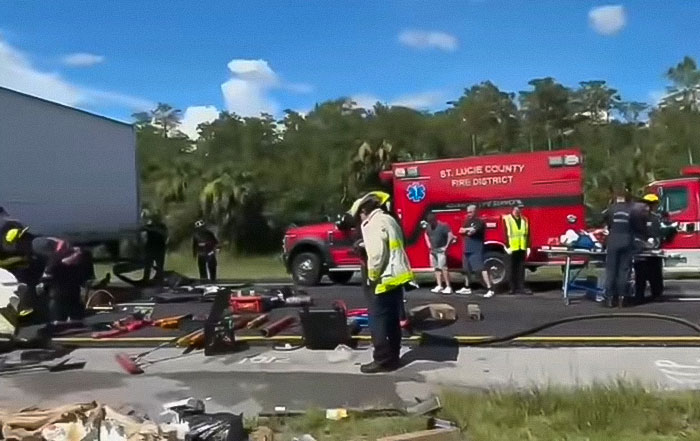 Emergency responders at a crash scene involving a truck after an illegal U-turn causing multiple fatalities.