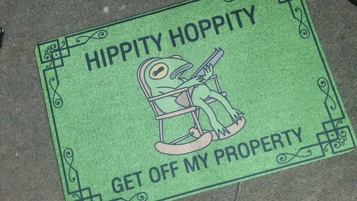 Green doormat with a funny cartoon frog and humorous sign reminding us not to take life too seriously.