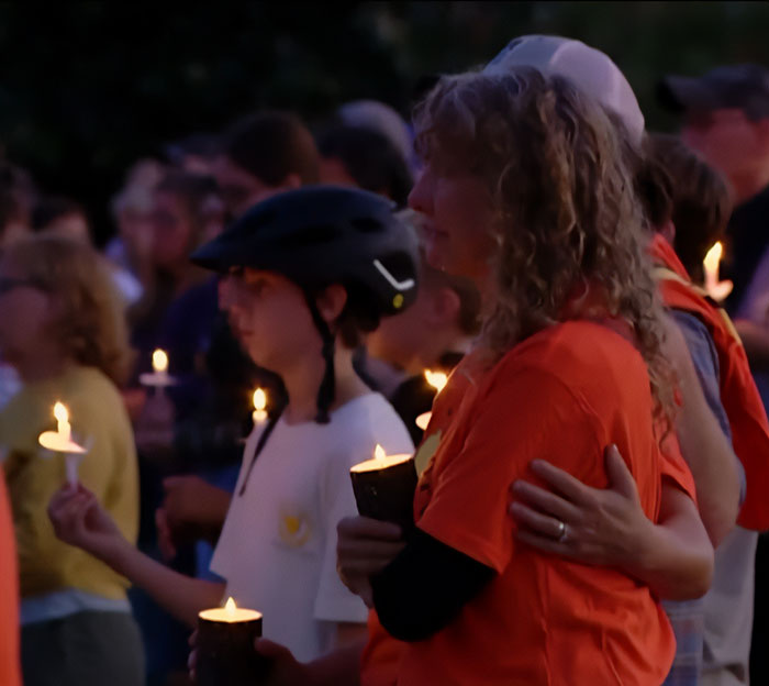 People holding candles at a vigil, reflecting concern over Minneapolis school attacker&rsquo;s mother not cooperating with cops.