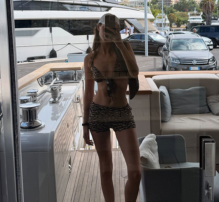 Woman in tiger print bikini taking yacht mirror selfie during Leonardo DiCaprio PDA-filled yacht trip with girlfriend