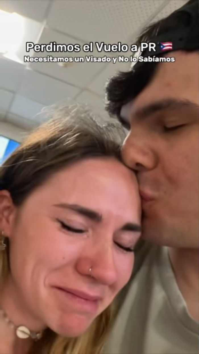Tearful influencer at airport with partner, blaming ChatGPT for missed flight and emotional distress.
