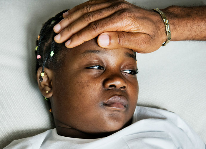 Tired person lying down with a hand on forehead, reflecting wild times Walmart employees felt underpaid at work.