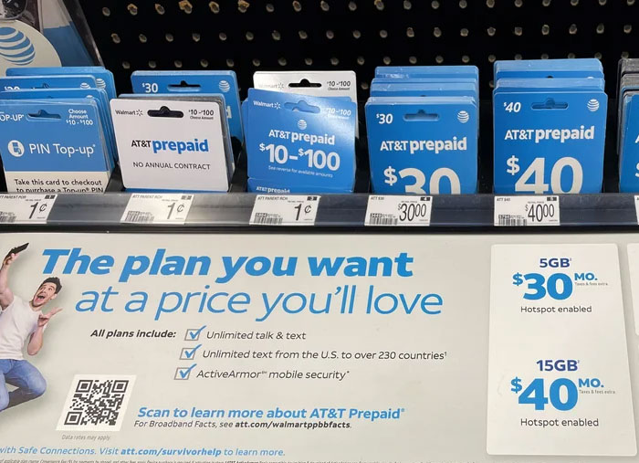 AT&T prepaid phone cards displayed at Walmart, illustrating challenges Walmart employees face during work.