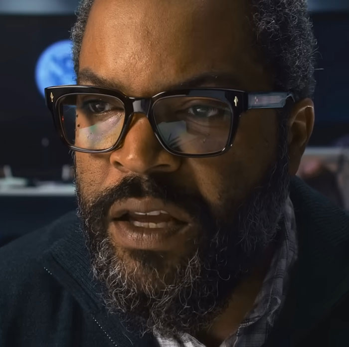 Close-up of Ice Cube wearing glasses, with a serious expression, related to War Of The Worlds movie review score. - 6
