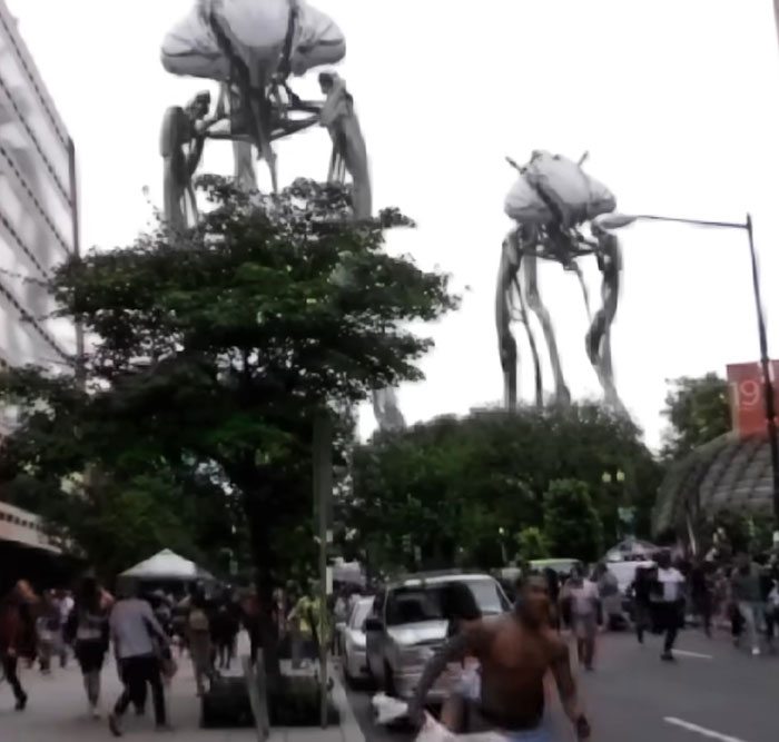 People running in a city street with large alien tripods towering above, referencing Ice Cube War Of The Worlds meme scene.