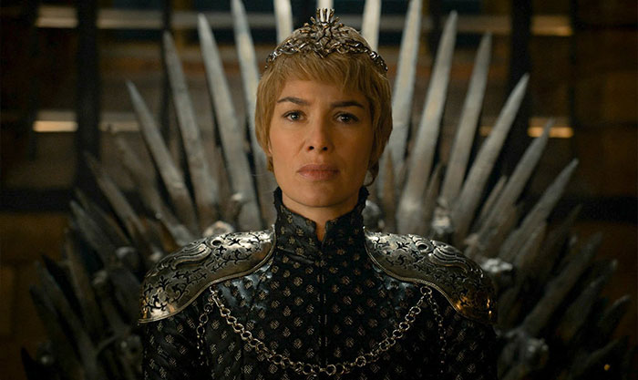Woman dressed in medieval armor sitting on an iron throne, representing strength and real-life confessions every water sign will recognize