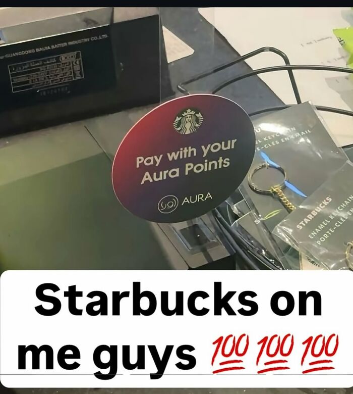 A Starbucks counter displaying a sign to pay with Aura Points, featured in daily cursed images on IG.