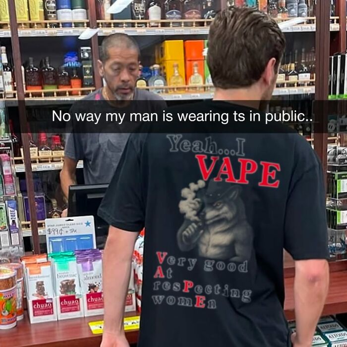 Man wearing a black vape-themed shirt in a store with a cashier, featured in daily cursed images on an IG page.