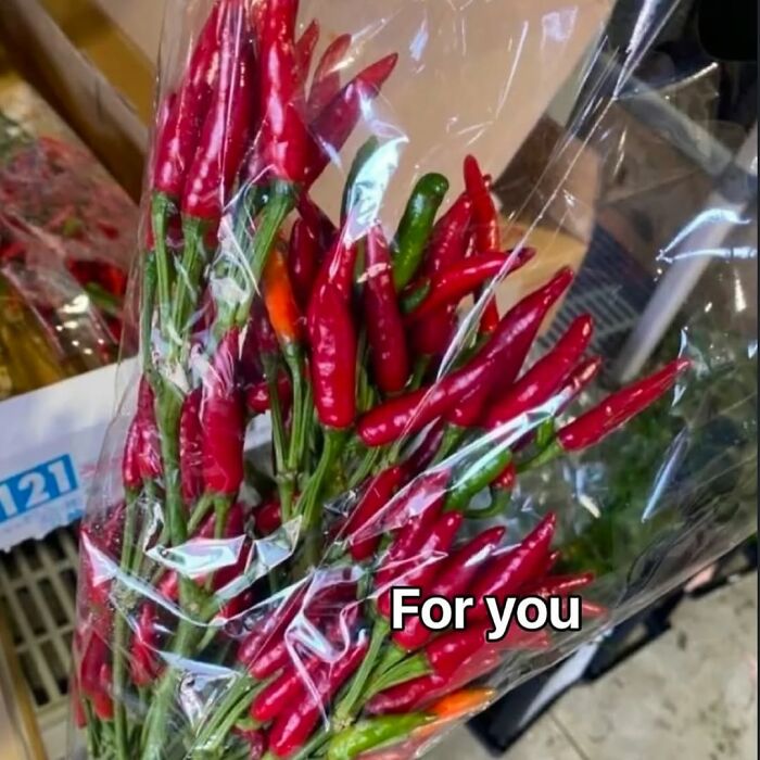 Bouquet of red and green chili peppers wrapped in plastic with the text For you, typical cursed images on IG page.