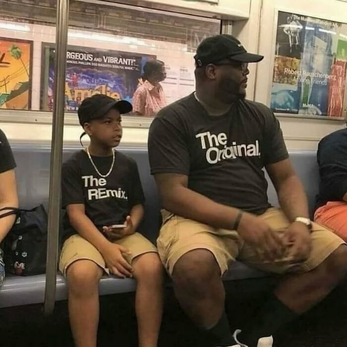 Two males wearing matching black shirts and beige shorts sitting next to each other on a subway train, creating a cursed image.