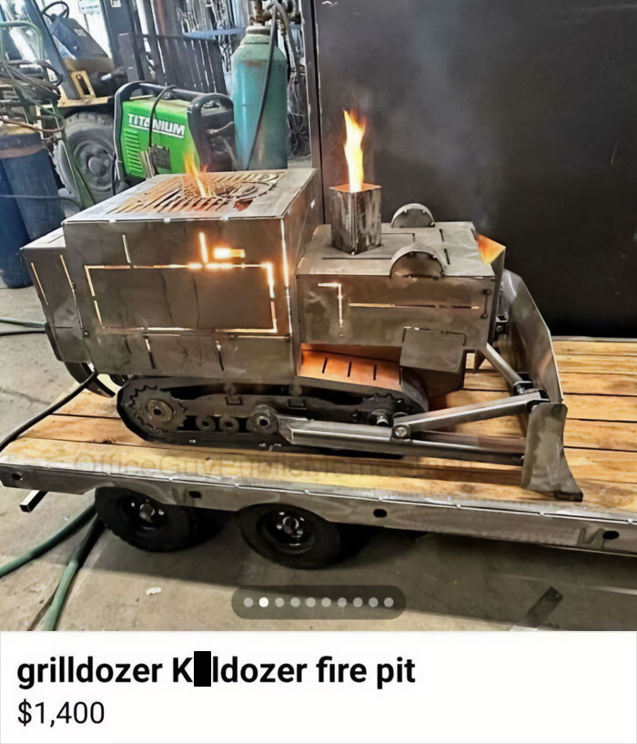 Metal bulldozer-shaped fire pit with flames, combining humor and unique design for those with a broken sense of humor.