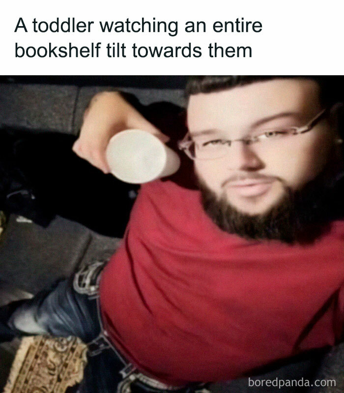 Man with glasses and beard in red shirt holding cup, illustrating humor with a broken sense of humor meme concept.