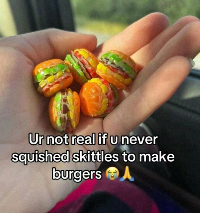 Hand holding colorful Skittles squished into small burger shapes, illustrating broken sense of humor meme.