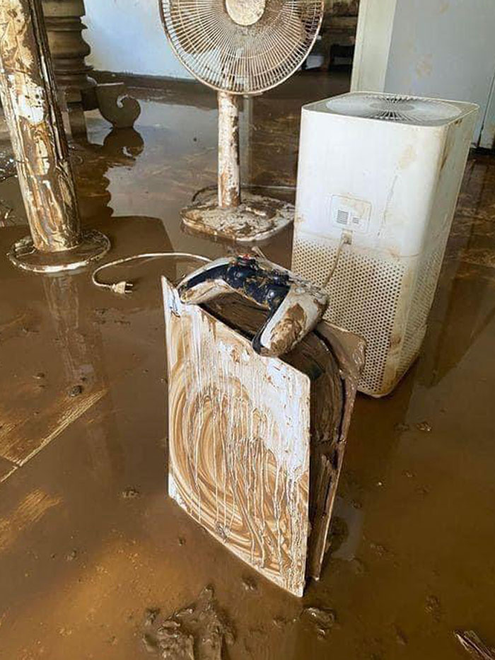 Flooded room with mud-covered household appliances showing Mother Nature doing things on its own terms.