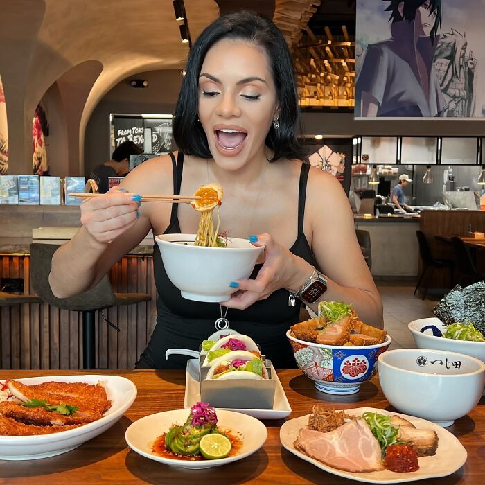 Woman enjoying a meal inside a restaurant, featured in terrifying footage of an SUV crashing into a couple dining.