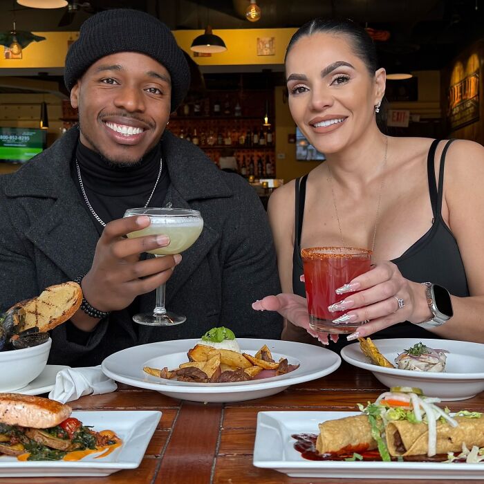 Couple enjoying drinks and food inside a restaurant before terrifying SUV crash footage incident occurs nearby.