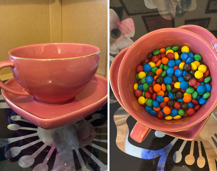 Pink heart-shaped cup and saucer with colorful M&M candies inside, showcasing witty and clever presentation style.
